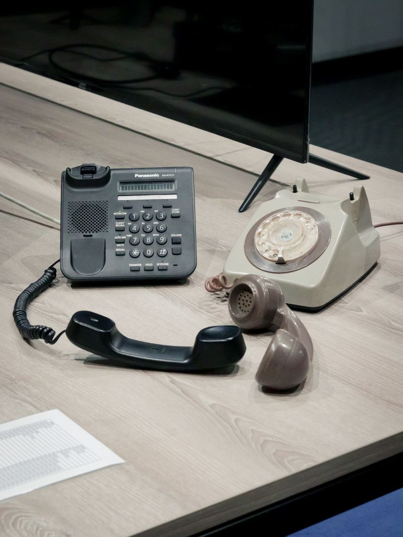 An old phone alongside a modern VoIP desk phone