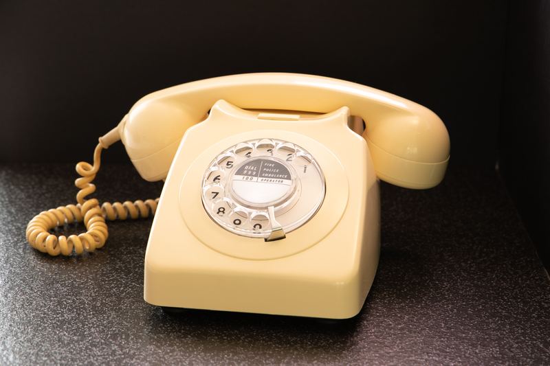 An old cream rotary telephone